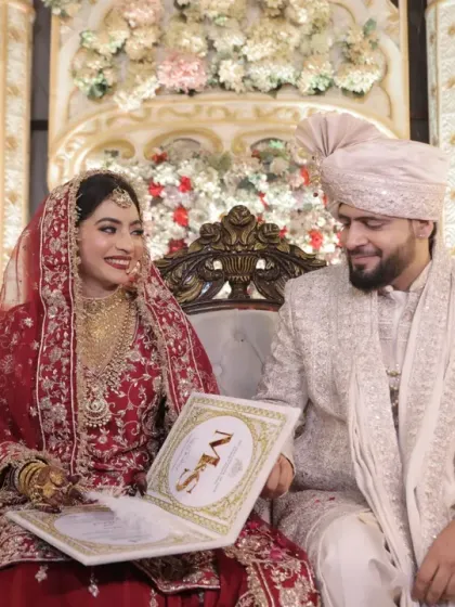 The signing of the Nikahnama, the marriage contract. This is a key moment in a Muslim wedding, and I focus on the couple's happy interaction as they make it official.