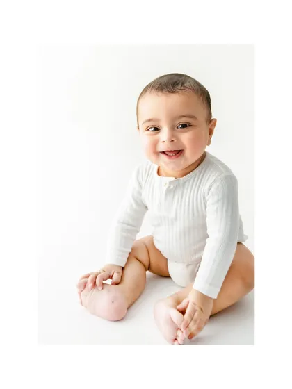 Six months is such a magical age, full of gummy grins and wobbly sits. This 'Halfway to One' milestone portrait captures that perfect moment of happy curiosity, a beautiful memory of the halfway point to their first big birthday.