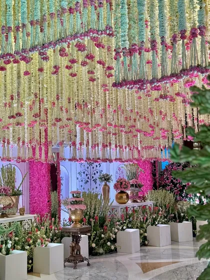 A floral paradise brought to life. We combined a ceiling of cascading flowers with traditional floor elements and decor to create a magical and immersive welcome experience. 🦚🪷