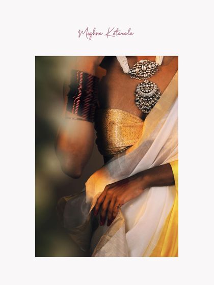 A close-up detail shot from a campaign, focusing on the interplay of textures. The shot highlights the metallic sheen of the blouse, the delicate weave of the saree, and the bold design of the traditional silver necklace.