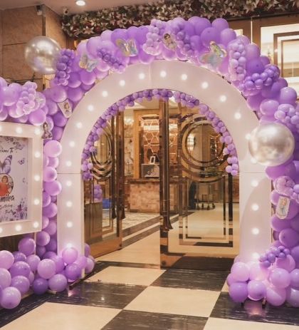 Make a grand entrance for your little one's party. We created this stunning balloon archway decorated with butterflies and a personalized welcome sign for a magical start to the celebration.