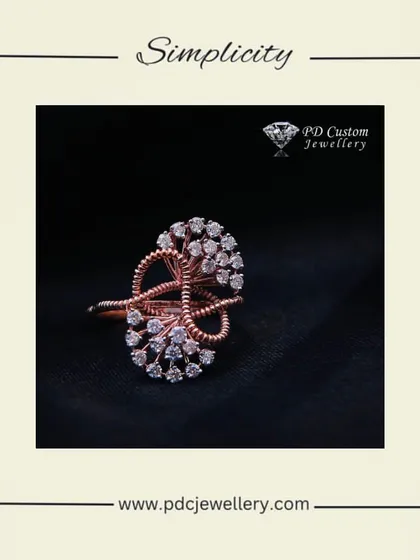 A simple yet elegant cocktail ring in 14kt rose gold. The intricate design is studded with natural diamonds, creating a beautiful piece that is both modern and timeless.