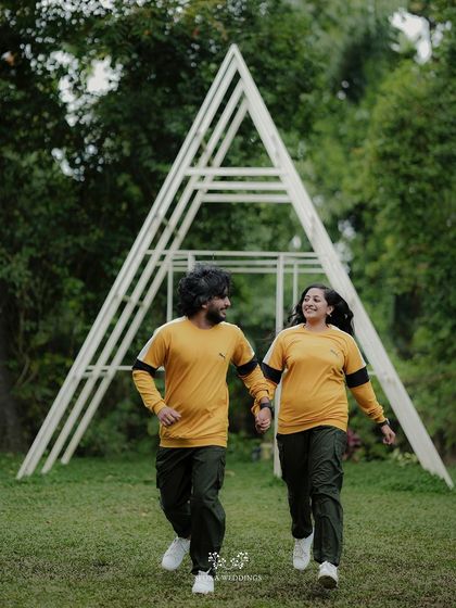Another joyful shot of the couple running and laughing, a perfect candid moment from their pre-wedding shoot.