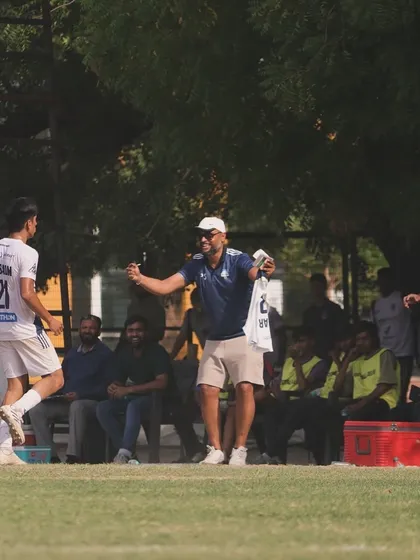 The passion of our coaching staff is evident on the sidelines, celebrating a goal and motivating the team.