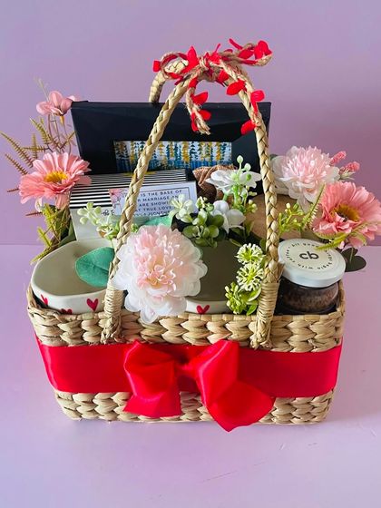 A full view of the romantic couple's hamper in a cane basket. It's a perfect gift to celebrate love.