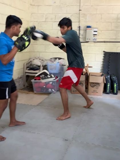 A student working on his punches with a coach.