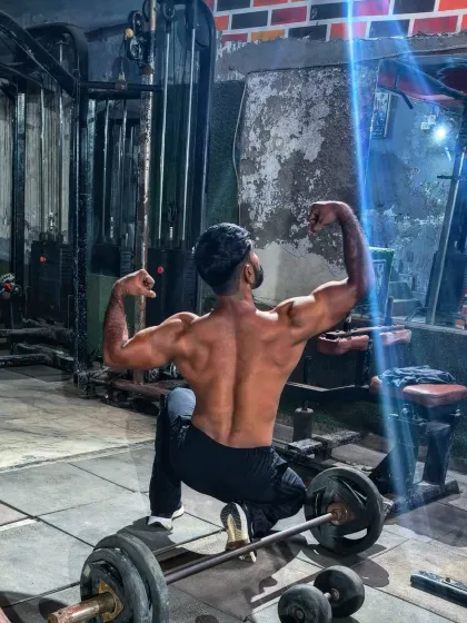 The result of working hard in private. This back double-bicep pose is a classic for a reason.