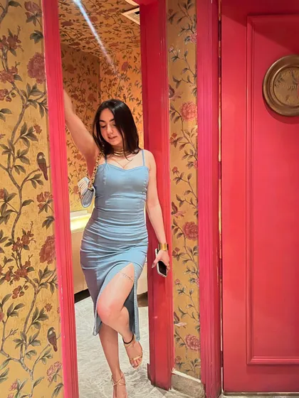 Posing in a doorway, this shot plays with frames and textures to create a more interesting fashion photo.