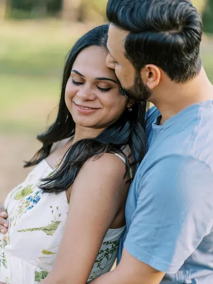 A close-up of the partner's tender kiss. The soft focus and warm light make this a beautifully romantic and emotional portrait.