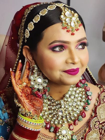 The complete look, showcasing how the heavy kundan jewelry, intricate lehenga, and bold makeup come together for a truly regal bridal style.
