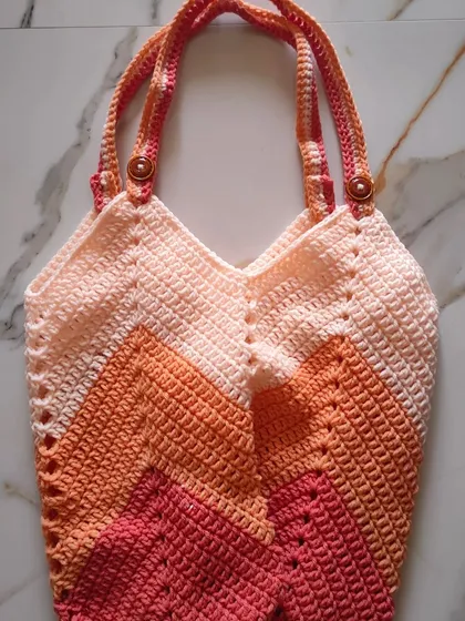I designed this Chevron Tulip Bag to be the perfect carry-all for my crochet projects. The sturdy chevron stitch gives it a lovely shape and texture, and it’s spacious enough to hold plenty of yarn and tools for crafting on the go.