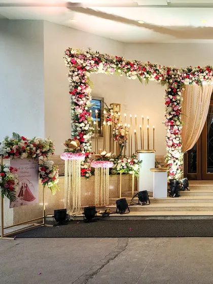 Another angle of the ceremonial entrance, showing the personalized welcome sign and the beautiful arrangement of flowers and candles.