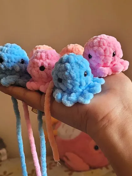 Here are some of my little octopus plushies lined up and ready to go. I can add a keyring loop to them so you can attach them to your bag or keys.