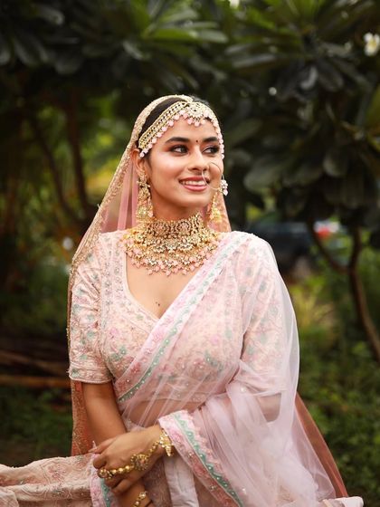 A beautiful portrait of the bride. The makeup is fresh and youthful, with a focus on her radiant smile.