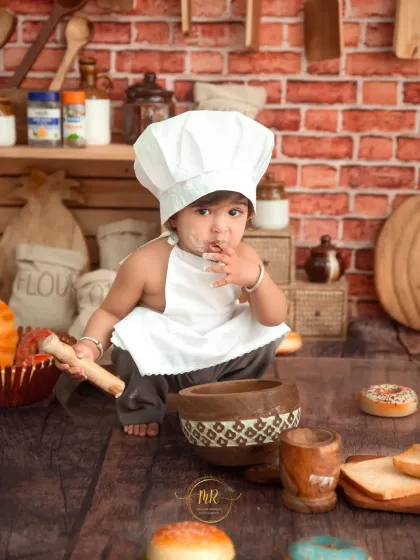A candid shot of the 'Little Chef' tasting his ingredients while playing with a toy mortar and pestle.