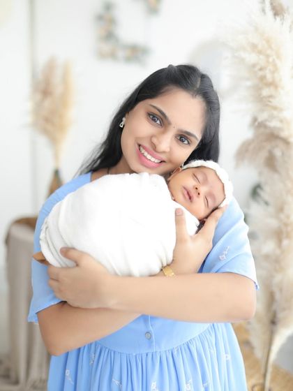Pure love in a mother's arms. The smile on this mom's face as she holds her sleeping newborn says everything. A truly blessed moment.