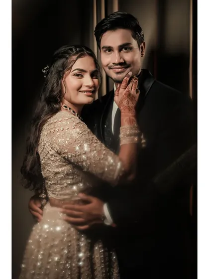 A classic, warm portrait of Amit and Pallavi, where the bride's gentle touch on the groom's face shows their deep affection.