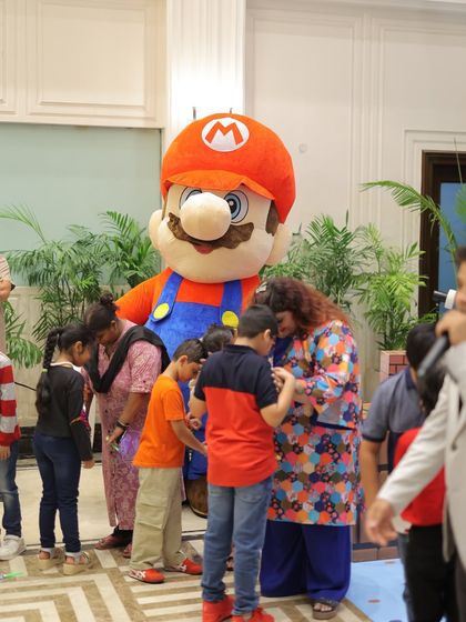 A Super Mario mascot interacts with young guests, creating a memorable and exciting experience. Having a favorite character at the party adds a special layer of fun and engagement.