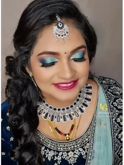 A close-up of Akshatha's stunning reception makeup. She wanted a glamorous look with glitter, and I loved creating this bold blue smokey eye to match her velvet lehenga.