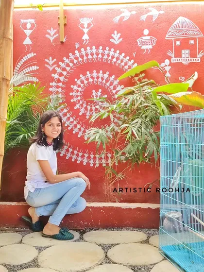Me with a completed Warli wall mural, an example of the kind of project you can create after taking my comprehensive Warli course.