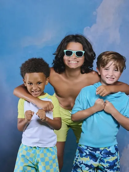 A studio shot for a kids' swimwear line. Even with a simple painted backdrop, we can create a fun, summery vibe. The key is directing the kids to interact naturally and capturing their bright energy.
