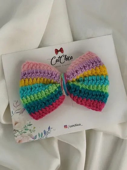 The same pastel rainbow bow, shown against a simple white background to highlight the beautiful colors.