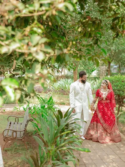 A candid moment during a stroll. We love how the natural foliage frames the couple, creating a sense of intimacy in this destination wedding photo.
