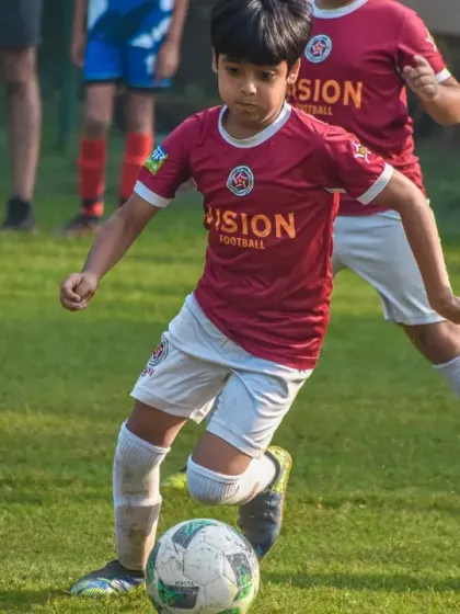 Another action shot from the Pride Cup, with a U10 player focused on controlling the ball under pressure from a teammate.