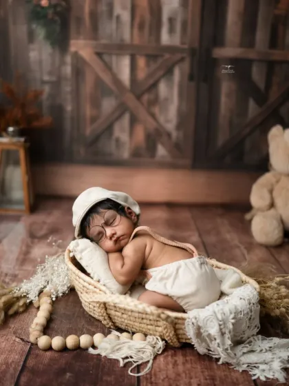 A sleepy newborn wearing a little cap and glasses, dreaming in a rustic basket. I love adding these whimsical touches to create truly unique and charming baby photos.