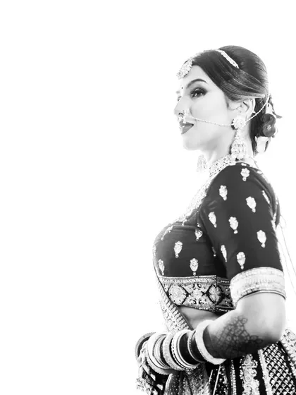 A high-contrast black and white portrait that feels like a piece of art. This style emphasizes the bride's features and the intricate details of her attire.