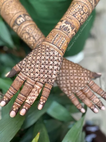 A fun design with "Veg" and "Non-Veg" written on the fingers. A great example of how we can add a playful, personal touch to your mehendi.