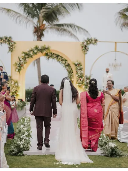 The bride being walked down the aisle by her parents, a poignant and emotional moment we are honored to capture.