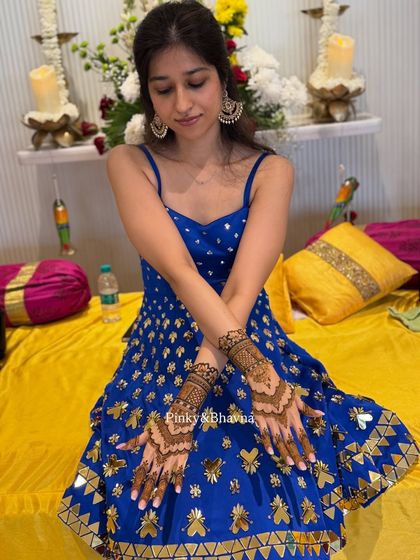 This client looks radiant in her blue dress, with her minimal mehndi adding the perfect festive touch. The design is light but detailed, ideal for any celebration.