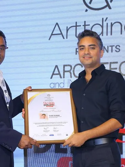 Vijay receiving a certificate of appreciation for his participation in the design debate.
