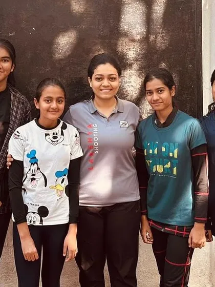 A coach with her group of young female shooters at the Maharashtra Rifle Association. This image highlights the supportive and tight-knit groups that form under the guidance of my mentors.