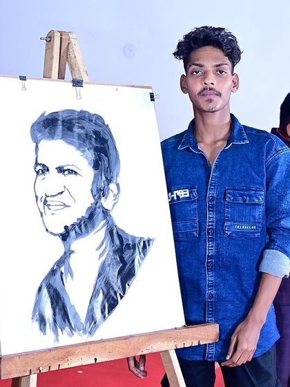 Presenting my completed portrait of Puneeth Rajkumar on stage. This piece is a heartfelt tribute, and performing it live allows me to share that emotion with a large audience.