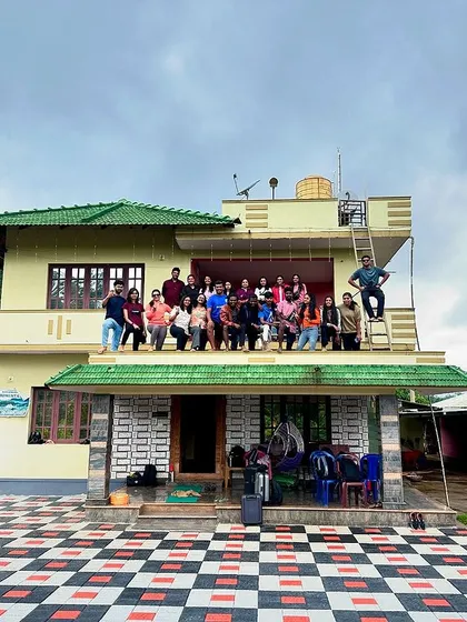The whole group gathered for a photo at our homestay, with some adventurous members even climbing onto the roof.