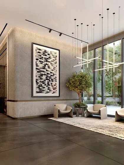The lounge area of the commercial tower, where glass walls dissolve the boundary between exterior and interior. Bespoke lighting installations and curated art pieces elevate the aesthetic, serving as focal points that mirror the architecture’s fluid geometry.