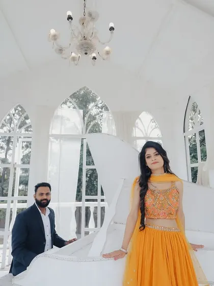 An elegant and classic shot in a studio designed to look like a European conservatory, complete with a white piano. This set is perfect for a sophisticated and timeless look.