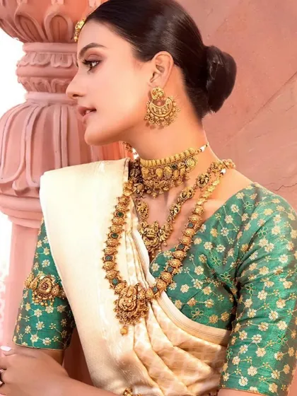 A full look at the South Indian bridal styling for a jewellery campaign. The magnificent gold temple jewellery stands out beautifully against the traditional off-white and green Kerala saree, creating a timeless and culturally rich bridal statement.