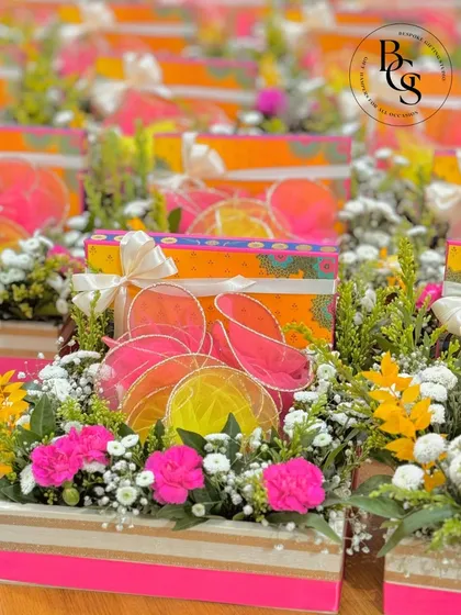 I believe in the beauty of combining fresh, natural elements with gourmet treats. This hamper, featuring a vibrant floral arrangement in a rustic wooden planter, is perfect for wedding announcements or as a welcoming gift, bringing a touch of nature and elegance to any celebration.