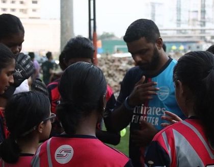 A candid shot of Coach Anil mentoring the girls' team during a huddle. These moments of guidance are invaluable.