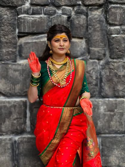 A devotional pose, capturing the essence of her song "Udo Ambabaicha".