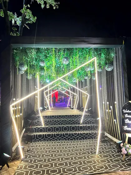 Your guests' first impression matters. We crafted this futuristic Sangeet entrance tunnel using geometric neon lights, hanging disco balls, and a dramatic patterned walkway to build excitement from the moment they arrived.