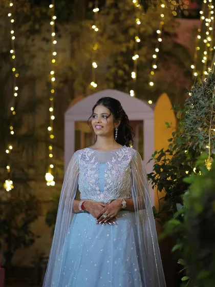 Straight out of a fairytale. This bride's sangeet look in a dreamy powder blue gown with a cape is absolutely magical, especially under the fairy lights.
