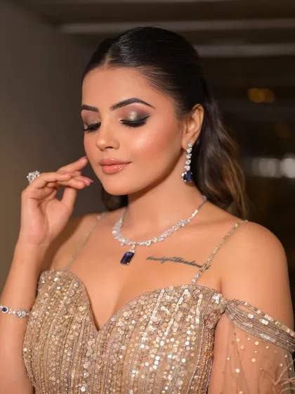 The eyes tell the story here. This close-up shows the blend of the smoky eyeshadow and the pop of glitter, a perfect technique for a glamorous evening event.
