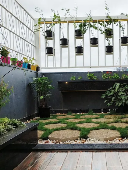 Even a city terrace can become a personal sanctuary. For the 'Opulent Abode' penthouse, I designed this peaceful garden with a calming Buddha statue, a small water feature, and a mix of potted and hanging plants to create a lush escape from the urban environment.