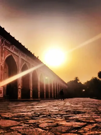 The long, arcaded walkway of Humayun's Tomb at sunset. This perspective highlights the scale of the complex and the importance of the charbagh, or four-part garden layout.