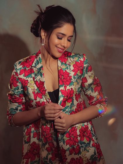 Karunya in a moment of quiet confidence. The soft lighting and her gentle smile create a beautiful and elegant portrait.