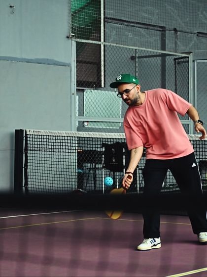 A player lunges for a low shot near the net. The game is fast, fun, and keeps you on your toes.